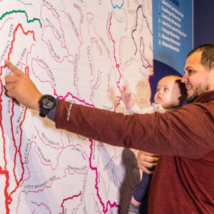 man and child looking at an Ohio map