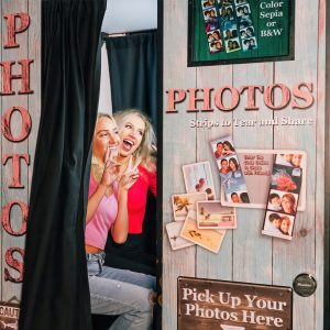 2 teens taking photobooth photos